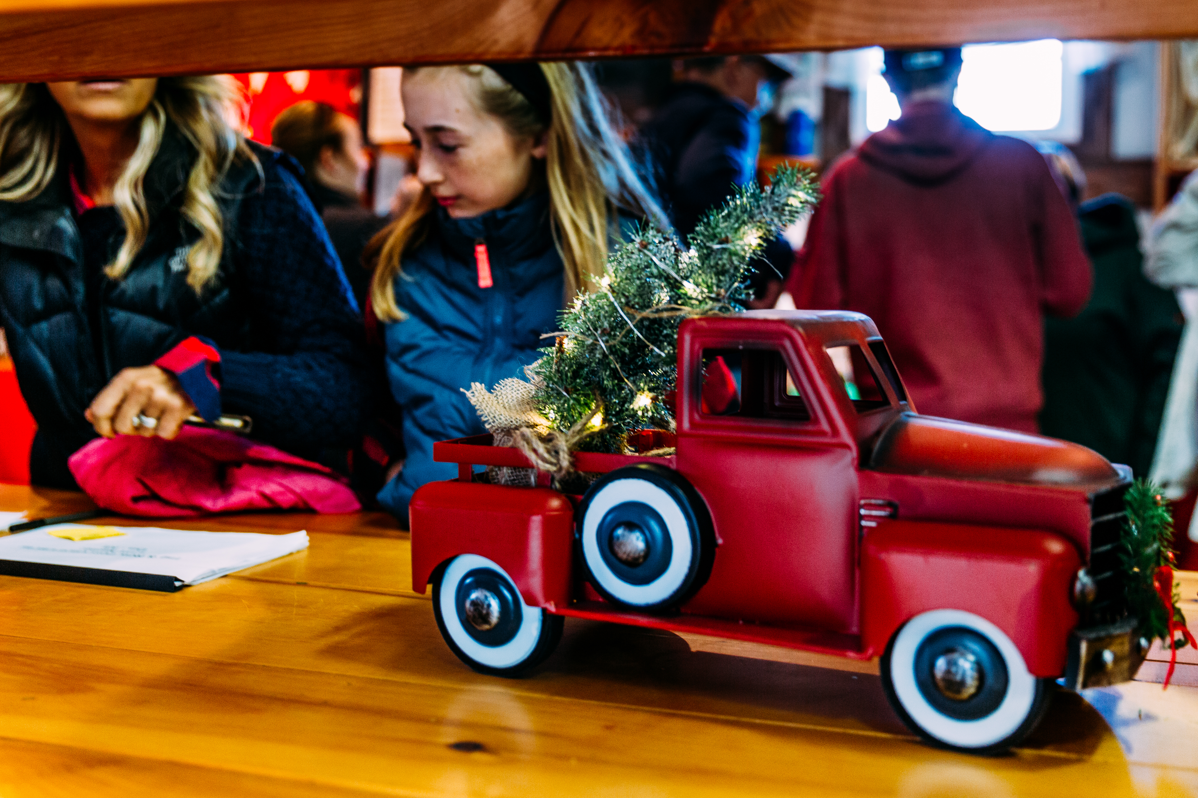miniature red pickup truck with christmas tree on top